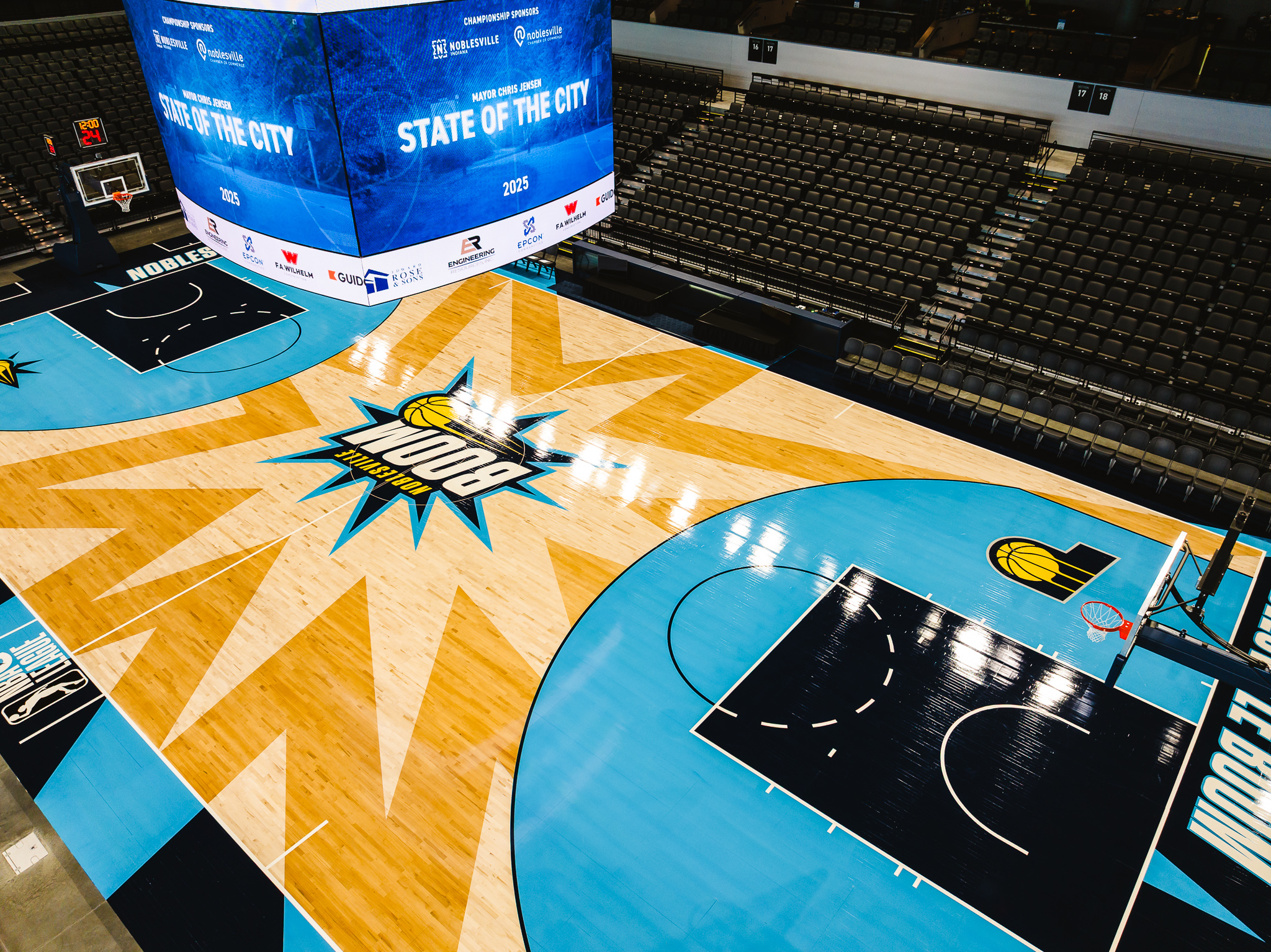 Image of the court at the Riverview Health Arena with digital signage for the State of the City address