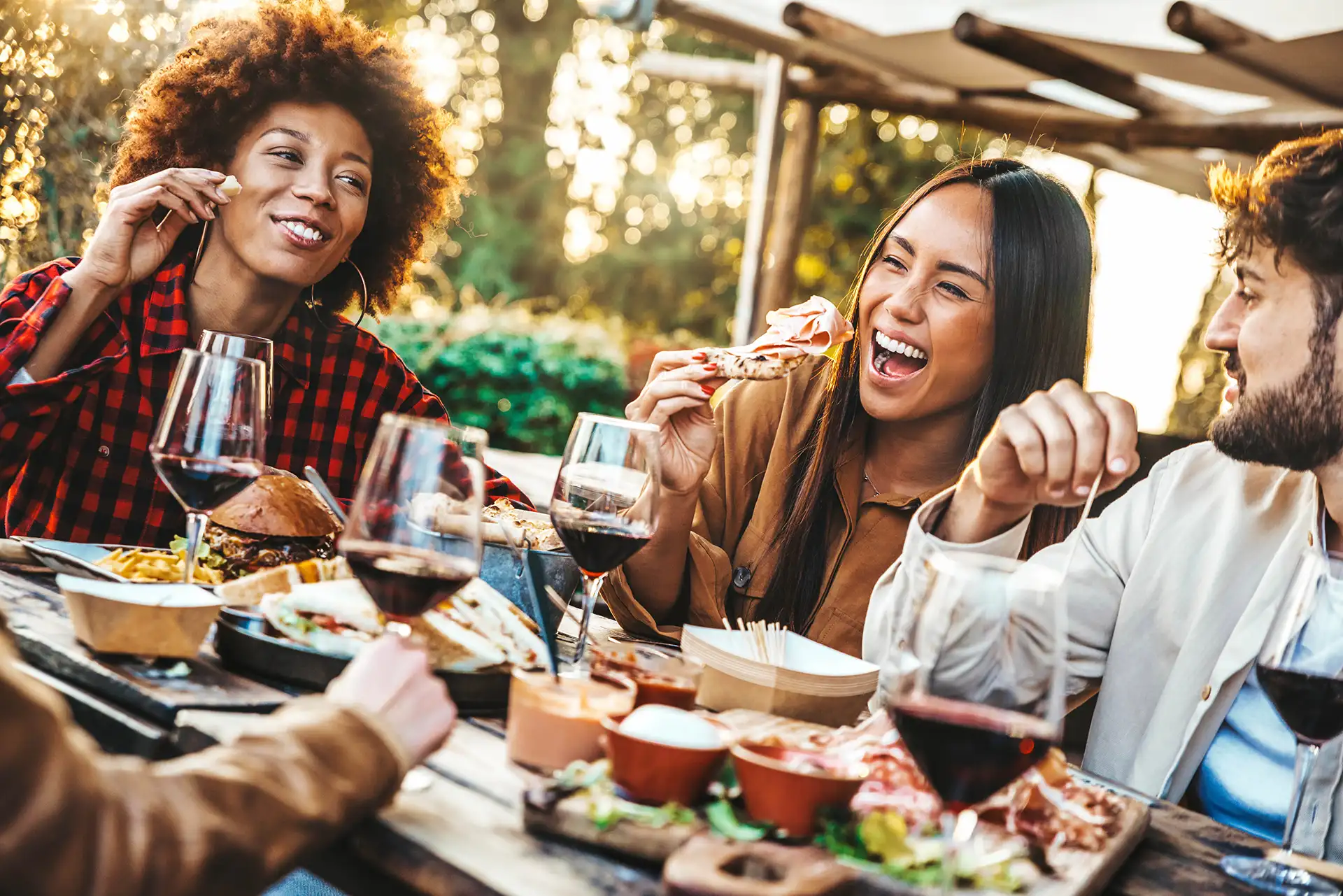 Friends Dining At An Outdoor Setting At Restaurant.